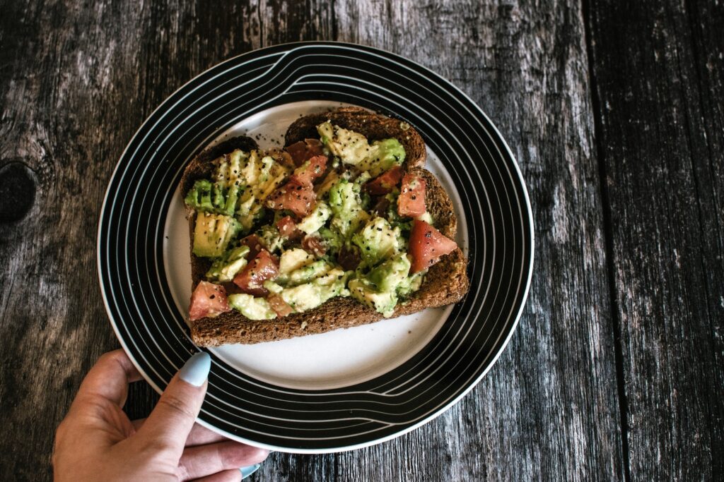 Person Holding Plate With Food